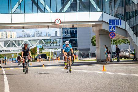 MOSCOW, RUSSIA - AUGUST 25, 2019: Ironman Cycling competition, cyclist athletes riding a race. Ironstar Crocus Fitness Triathlon.のeditorial素材