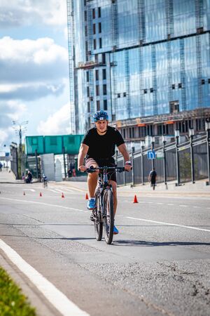 MOSCOW, RUSSIA - AUGUST 25, 2019: Ironman Cycling competition, cyclist athletes riding a race. Ironstar Crocus Fitness Triathlon.のeditorial素材