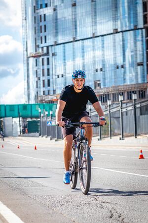 MOSCOW, RUSSIA - AUGUST 25, 2019: Ironman Cycling competition, cyclist athletes riding a race. Ironstar Crocus Fitness Triathlon.のeditorial素材