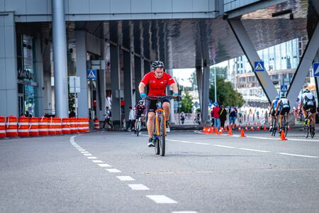MOSCOW, RUSSIA - AUGUST 25, 2019: Ironman Cycling competition, cyclist athletes riding a race. Ironstar Crocus Fitness Triathlon.のeditorial素材