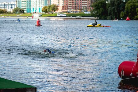 MOSCOW, RUSSIA - AUGUST 25, 2019: Ironman Swimmers on the open waters event Moscow river. Ironstar Crocus Fitness Triathlon 2019.のeditorial素材