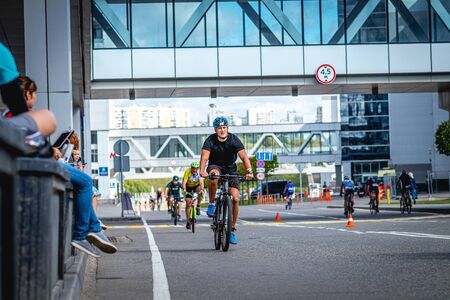 MOSCOW, RUSSIA - AUGUST 25, 2019: Ironman Cycling competition, cyclist athletes riding a race. Ironstar Crocus Fitness Triathlon.のeditorial素材