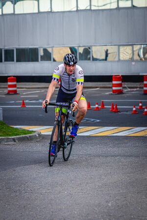MOSCOW, RUSSIA - AUGUST 25, 2019: Ironman Cycling competition, cyclist athletes riding a race. Ironstar Crocus Fitness Triathlon.のeditorial素材