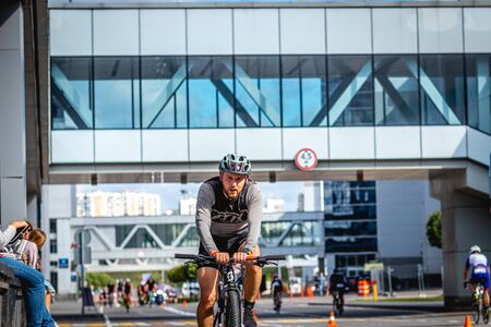 MOSCOW, RUSSIA - AUGUST 25, 2019: Ironman Cycling competition, cyclist athletes riding a race. Ironstar Crocus Fitness Triathlon.のeditorial素材