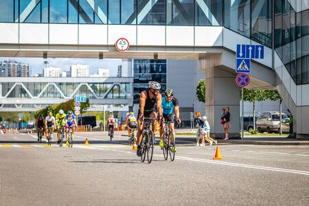 MOSCOW, RUSSIA - AUGUST 25, 2019: Ironman Cycling competition, cyclist athletes riding a race. Ironstar Crocus Fitness Triathlon.のeditorial素材