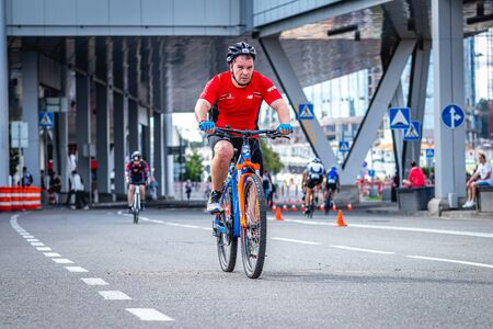 MOSCOW, RUSSIA - AUGUST 25, 2019: Ironman Cycling competition, cyclist athletes riding a race. Ironstar Crocus Fitness Triathlon.のeditorial素材