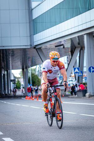 MOSCOW, RUSSIA - AUGUST 25, 2019: Ironman Cycling competition, cyclist athletes riding a race. Ironstar Crocus Fitness Triathlon.のeditorial素材