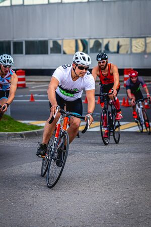 MOSCOW, RUSSIA - AUGUST 25, 2019: Ironman Cycling competition, cyclist athletes riding a race. Ironstar Crocus Fitness Triathlon.のeditorial素材
