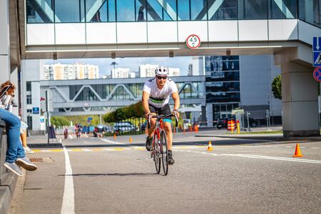 MOSCOW, RUSSIA - AUGUST 25, 2019: Ironman Cycling competition, cyclist athletes riding a race. Ironstar Crocus Fitness Triathlon.のeditorial素材
