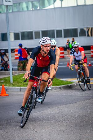 MOSCOW, RUSSIA - AUGUST 25, 2019: Ironman Cycling competition, cyclist athletes riding a race. Ironstar Crocus Fitness Triathlon.のeditorial素材