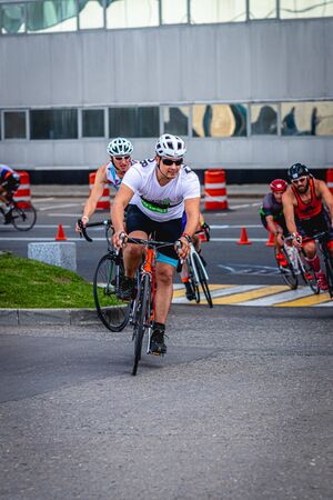 MOSCOW, RUSSIA - AUGUST 25, 2019: Ironman Cycling competition, cyclist athletes riding a race. Ironstar Crocus Fitness Triathlon.のeditorial素材