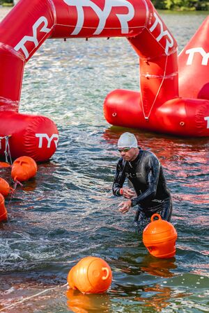 MOSCOW, RUSSIA - AUGUST 25, 2019: Ironman Swimmers on the open waters event Moscow river. Ironstar Crocus Fitness Triathlon 2019.のeditorial素材