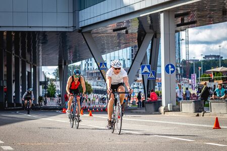 MOSCOW, RUSSIA - AUGUST 25, 2019: Ironman Cycling competition, cyclist athletes riding a race. Ironstar Crocus Fitness Triathlon.のeditorial素材