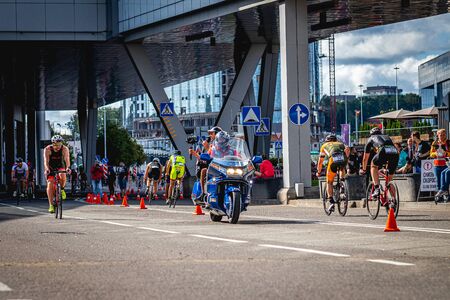 MOSCOW, RUSSIA - AUGUST 25, 2019: Ironman Cycling competition, cyclist athletes riding a race. Ironstar Crocus Fitness Triathlon.のeditorial素材