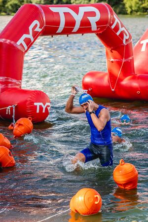 MOSCOW, RUSSIA - AUGUST 25, 2019: Ironman Swimmers on the open waters event Moscow river. Ironstar Crocus Fitness Triathlon 2019.のeditorial素材