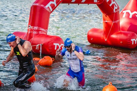 MOSCOW, RUSSIA - AUGUST 25, 2019: Ironman Swimmers on the open waters event Moscow river. Ironstar Crocus Fitness Triathlon 2019.のeditorial素材