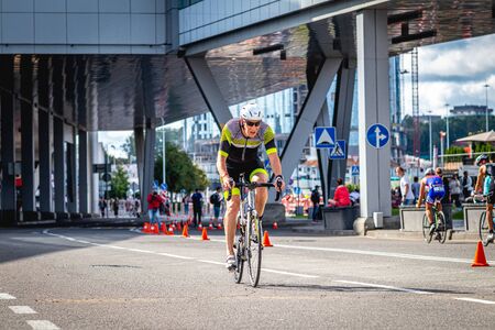 MOSCOW, RUSSIA - AUGUST 25, 2019: Ironman Cycling competition, cyclist athletes riding a race. Ironstar Crocus Fitness Triathlon.のeditorial素材