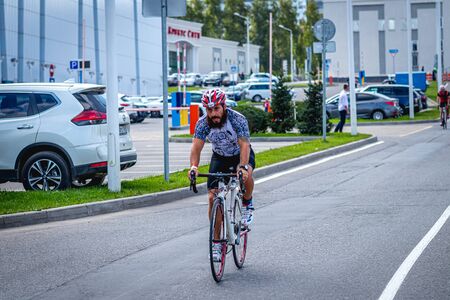 MOSCOW, RUSSIA - AUGUST 25, 2019: Ironman Cycling competition, cyclist athletes riding a race. Ironstar Crocus Fitness Triathlon.のeditorial素材