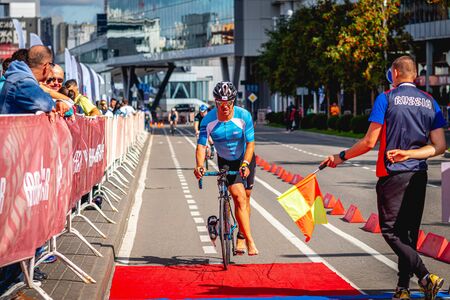 MOSCOW, RUSSIA - AUGUST 25, 2019: Ironman Cycling competition, cyclist athletes riding a race. Ironstar Crocus Fitness Triathlon.のeditorial素材