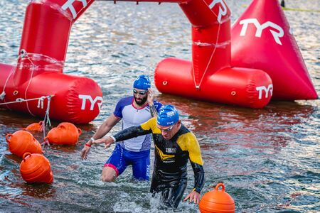 MOSCOW, RUSSIA - AUGUST 25, 2019: Ironman Swimmers on the open waters event Moscow river. Ironstar Crocus Fitness Triathlon 2019.のeditorial素材
