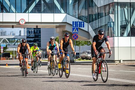 MOSCOW, RUSSIA - AUGUST 25, 2019: Ironman Cycling competition, cyclist athletes riding a race. Ironstar Crocus Fitness Triathlon.のeditorial素材