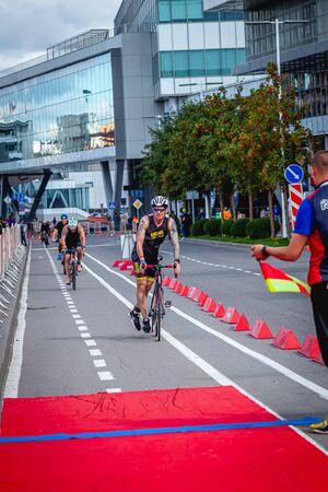 MOSCOW, RUSSIA - AUGUST 25, 2019: Ironman Cycling competition, cyclist athletes riding a race. Ironstar Crocus Fitness Triathlon.のeditorial素材