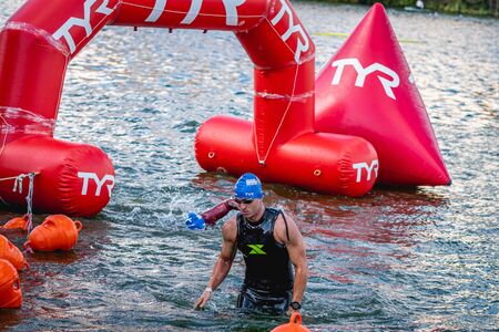 MOSCOW, RUSSIA - AUGUST 25, 2019: Ironman Swimmers on the open waters event Moscow river. Ironstar Crocus Fitness Triathlon 2019.のeditorial素材