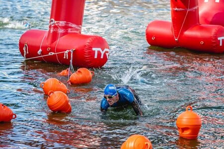 MOSCOW, RUSSIA - AUGUST 25, 2019: Ironman Swimmers on the open waters event Moscow river. Ironstar Crocus Fitness Triathlon 2019.のeditorial素材