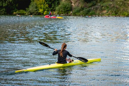 MOSCOW, RUSSIA - AUGUST 25, 2019: Young woman enjoys her kayak workout in the hot weather at Moscow river.のeditorial素材