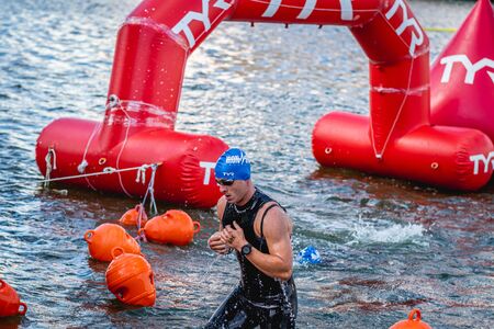 MOSCOW, RUSSIA - AUGUST 25, 2019: Ironman Swimmers on the open waters event Moscow river. Ironstar Crocus Fitness Triathlon 2019.のeditorial素材
