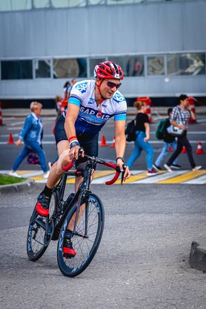 MOSCOW, RUSSIA - AUGUST 25, 2019: Ironman Cycling competition, cyclist athletes riding a race. Ironstar Crocus Fitness Triathlon.のeditorial素材