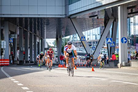MOSCOW, RUSSIA - AUGUST 25, 2019: Ironman Cycling competition, cyclist athletes riding a race. Ironstar Crocus Fitness Triathlon.のeditorial素材