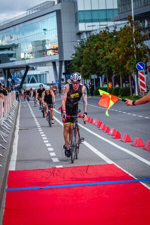MOSCOW, RUSSIA - AUGUST 25, 2019: Ironman Cycling competition, cyclist athletes riding a race. Ironstar Crocus Fitness Triathlon.のeditorial素材