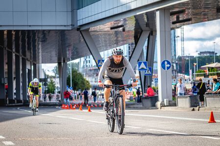 MOSCOW, RUSSIA - AUGUST 25, 2019: Ironman Cycling competition, cyclist athletes riding a race. Ironstar Crocus Fitness Triathlon.のeditorial素材