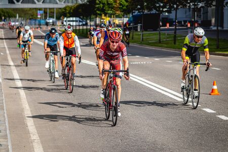 MOSCOW, RUSSIA - AUGUST 25, 2019: Ironman Cycling competition, cyclist athletes riding a race. Ironstar Crocus Fitness Triathlon.のeditorial素材