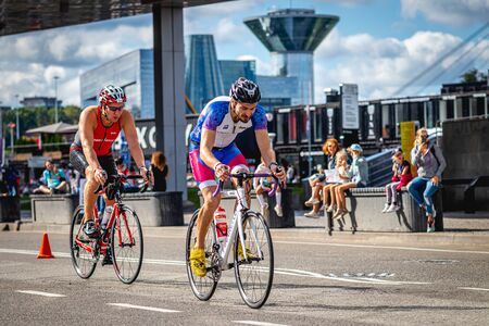 MOSCOW, RUSSIA - AUGUST 25, 2019: Ironman Cycling competition, cyclist athletes riding a race. Ironstar Crocus Fitness Triathlon.のeditorial素材