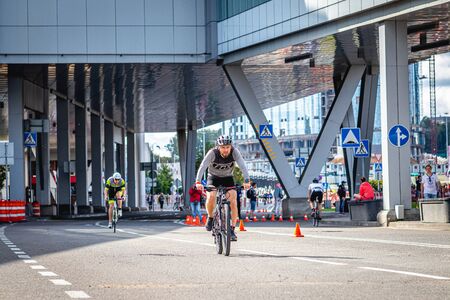 MOSCOW, RUSSIA - AUGUST 25, 2019: Ironman Cycling competition, cyclist athletes riding a race. Ironstar Crocus Fitness Triathlon.のeditorial素材