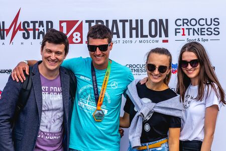 MOSCOW, RUSSIA - AUGUST 25, 2019: Athletes with medals on IRONSTAR CROCUS FITNESS TRIATHLON 2019.のeditorial素材