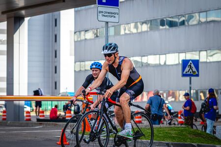 MOSCOW, RUSSIA - AUGUST 25, 2019: Ironman Cycling competition, cyclist athletes riding a race.のeditorial素材