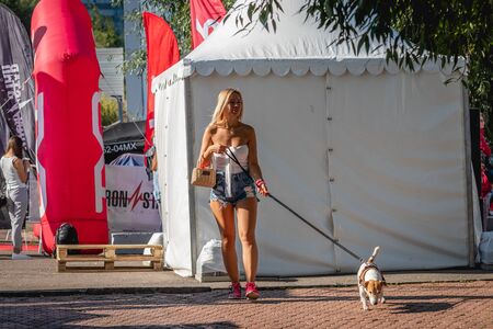 MOSCOW, RUSSIA - AUGUST 25, 2019: Cute young woman with Jack Russell Terrier dog. Sexy lady with her dog.のeditorial素材