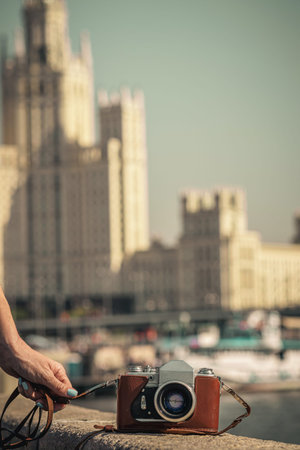 Retro vintage old camera on a city background. Retro color. Vintage photography.