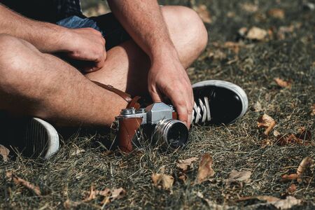 Man holding retro camera. Vintage camera. Fashion Photographer.の写真素材