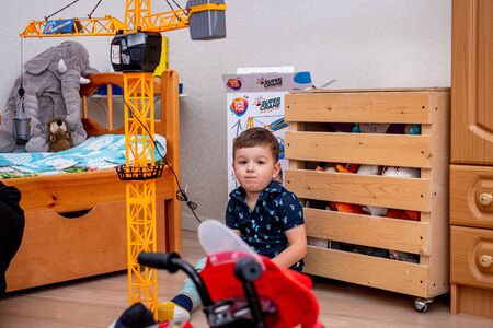 MOSCOW, RUSSIA - OCTOBER 12, 2019: Kid boy playing with toys at home or kindergarden.のeditorial素材