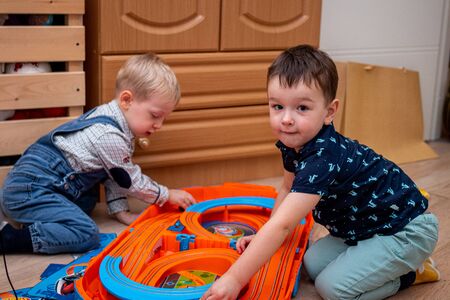 MOSCOW, RUSSIA - OCTOBER 12, 2019: Kid boy playing with toys at home or kindergarden.のeditorial素材