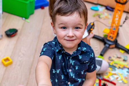 MOSCOW, RUSSIA - OCTOBER 12, 2019: Kid boy playing with toys at home or kindergarden.のeditorial素材