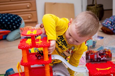 MOSCOW, RUSSIA - OCTOBER 12, 2019: Kid boy playing with toys at home or kindergarden.のeditorial素材
