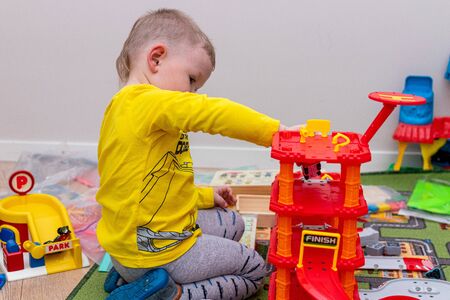 MOSCOW, RUSSIA - OCTOBER 12, 2019: Kid boy playing with toys at home or kindergarden.のeditorial素材