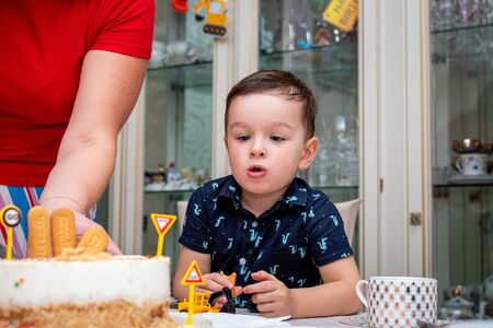 MOSCOW, RUSSIA - OCTOBER 12, 2019: Cute 3 years little boy and birthday cake.のeditorial素材