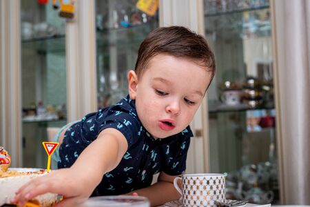 MOSCOW, RUSSIA - OCTOBER 12, 2019: Cute 3 years little boy and birthday cake.のeditorial素材