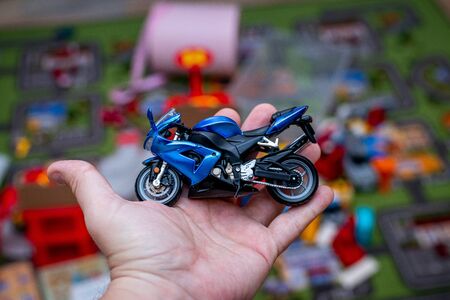 Cool toy speed bike in man hand, indoors shot.の写真素材